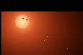 (c) NASA/JPL-Caltech Vue d'artiste du système TRAPPIST-1 où 2 exoplanètes sur 7 transitent devant l'étoile.